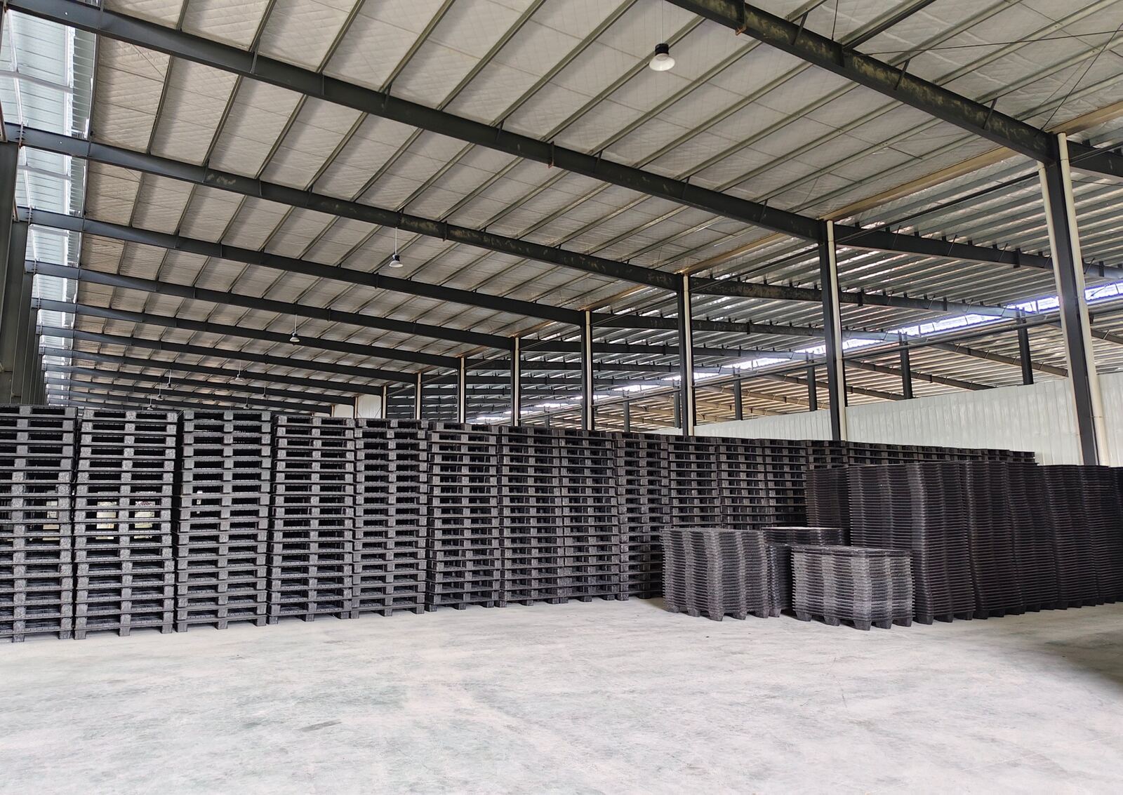 Finished recycled plastic pallets in storage